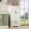 A white kitchen cabinet with two sets of double doors stands next to a green cabinet. The white cabinet is topped with a basket of oranges and a green decorative item. A large window with a view of trees and water is visible in the background. Náhľad obrázku produktu