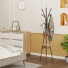 A bedroom scene with a dresser, bed, and a coat rack. Produktbild-Vorschau