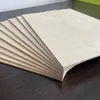 A stack of thin wooden sheets fanned out on a dark surface. Produktbild-Vorschau
