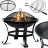 A black metal fire pit with a mesh cover and burning logs inside, along with a grilling grate and a separate fire pit bowl. Anteprima dell’immagine prodotto