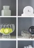 A white shelf unit with various decorative items on display. Produktbild-Vorschau