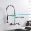 A chrome kitchen faucet mounted on a wall above a sink, with water flowing from the spout. Podgląd zdjęcia produktu