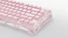 A close-up, angled shot of a pink mechanical keyboard on a white background. Produktbild-Vorschau