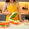 A person is using a multifunctional vegetable chopper in a kitchen setting. Náhľad obrázku produktu
