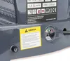Close-up of a gray device showing a fuse holder, a yellow warning sticker, and a voltage meter. Produktbild-Vorschau