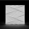 A 3D decorative wall panel with a wavy pattern, presented against a dark background with lighting that creates shadows and highlights. Produktbild-Vorschau