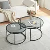 A living room scene with a sofa and two round coffee tables. Produktbild-Vorschau