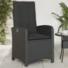 An outdoor chair on a patio with plants and a small table. Produktbild-Vorschau
