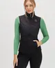 A woman is wearing a black vest over a green long-sleeved shirt. Podgląd zdjęcia produktu