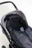 A close-up view of a baby stroller with a black footmuff inside. Produktbild-Vorschau