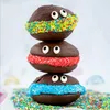 A stack of three chocolate cookies decorated to look like faces, with candy sprinkles around the middle and candy eyes. Náhled obrázku produktu