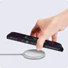 A hand is placing a smartphone onto a wireless charger. Voir les images du produit
