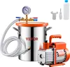 A VEVOR vacuum chamber and pump set is displayed against a white background. The set includes a stainless steel chamber with a pressure gauge and hose, and an orange and silver vacuum pump. Accessories like a wrench, screwdriver, and a bottle are also visi Náhľad obrázku produktu