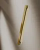 A gold-colored shower door profile is shown against a light gray and white background with a shadow. Produktbild-Vorschau