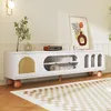 A white TV stand with rattan and glass doors is placed in a living room setting with a rug and a wall lamp. Anteprima dell’immagine prodotto
