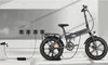 An electric bicycle is shown plugged into a charging station against a light gray wall. Anteprima dell’immagine prodotto