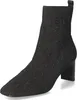 A black knitted ankle boot with a patterned design and a block heel, shown on a white background. Produktbild-Vorschau