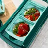 A close-up view of a vegetable chopper with chopped tomatoes and green peppers inside. Voir les images du produit