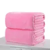 Two folded pink blankets are stacked on top of each other on a white surface. Produktbild-Vorschau