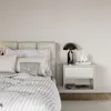 A bedroom scene with a bed and a nightstand. Produktbild-Vorschau