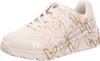 A single beige sneaker with a heart pattern on a white background. Voir les images du produit