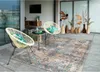 An outdoor seating area with chairs, a rug, and decorative vases. Náhled obrázku produktu