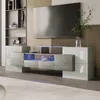 A modern living room setup featuring a large television mounted above a sleek, low TV cabinet with integrated LED lighting. Produktbild-Vorschau