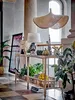 A console table with various decorative items and plants in a hallway. Produktbild-Vorschau