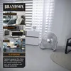 A silver fan is shown in a modern living room setting, with different room vignettes displayed on the left side. Voir les images du produit