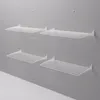 Four white folding wall-mounted drying racks are displayed on a light gray wall. Produktbild-Vorschau