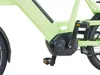A close-up view of the mid-drive motor and pedals of a light green electric bicycle. Produktbild-Vorschau