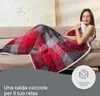 A woman is relaxing on a couch, covered by a plaid blanket. Podgląd zdjęcia produktu