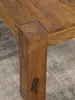 A close-up view of the corner of a wooden table, showing the joinery between the tabletop and a leg. Produktbild-Vorschau