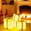 Christmas decorations in a living room setting, with a fireplace in the background. Podgląd zdjęcia produktu