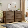 Two wooden dressers are placed side-by-side in a room, with decorative items on top and artwork on the wall. Náhled obrázku produktu