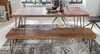 A wooden dining table and bench set with metal legs, placed on a patterned rug in a room with natural light. Podgląd zdjęcia produktu