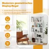 A modern white geometric display shelf filled with books and decorative items, placed next to a brown armchair in a well-lit room with a large window. Anteprima dell’immagine prodotto