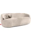A modern, beige sofa with two round decorative pillows. Produktbild-Vorschau
