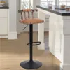 A bar stool is placed next to a kitchen island in a modern kitchen. Podgląd zdjęcia produktu