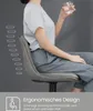 A person sitting on a bar stool, holding a glass of water. The image highlights the ergonomic design of the stool. Produktbild-Vorschau
