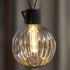 A close-up of a single, lit, decorative light bulb. Podgląd zdjęcia produktu