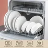 A dishwasher rack filled with white ceramic plates and bowls. Náhled obrázku produktu