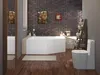 A modern bathroom with a brick wall, a corner bathtub, and a toilet. Voir les images du produit