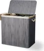 A grey bamboo laundry basket with a lid and beige lining, containing folded laundry. Náhľad obrázku produktu