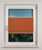 A window with a pleated blind partially covering it. The blind is orange and covers the middle section of the window. The top section shows the sky, and the bottom section shows trees and foliage. Produktbild-Vorschau