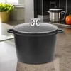 A black pot with a glass lid sits on a kitchen counter. Anteprima dell’immagine prodotto