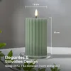 A green LED candle on a glass coaster, with foliage in the foreground. Podgląd zdjęcia produktu
