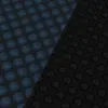 A close-up, diagonal view of a pool solar cover with a pattern of raised bubbles. The cover is split into two color sections: blue on the left and black on the right. Produktbild-Vorschau