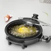 An electric frying pan with a glass lid is shown, with oil bubbling inside and a piece of food being fried. Eggshells are visible to the left, and a green chili pepper is floating in the air to the right. Produktbild-Vorschau