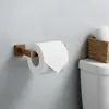 A toilet paper holder with a roll of toilet paper mounted on a wall next to a toilet tank with a basket of spare toilet paper rolls. Anteprima dell’immagine prodotto